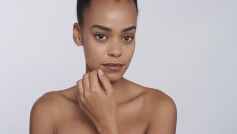 portrait beautiful african american woman touching face with hands caressing smooth healthy skin complexion enjoying perfect natural beauty on white background