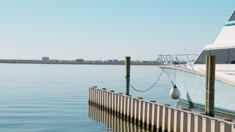 boat sits in harbor over crystal clear waters in the morning