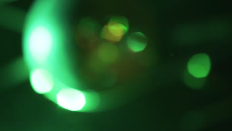 close-up-of-shiny-glitter-discoball-at-a-nightclub,-party-dancing-pop-lifestyle-b-roll,-bokeh
