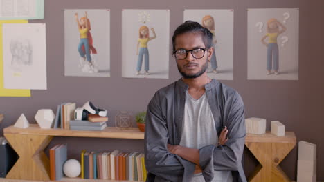 Portrait-Of-A-Serious-Man-With-Crossed-Arms-Looking-At-Camera-In-An-Animation-Studio