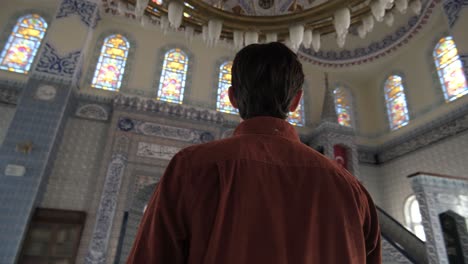 young guy looking in mosque