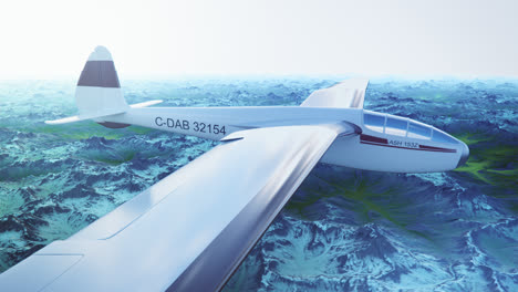 an aerial view of the white sailplane with no propeller calmly gliding in the sky, over snow-covered mountains. flying aerodynamic aircraft is a great way of spend leisure time.