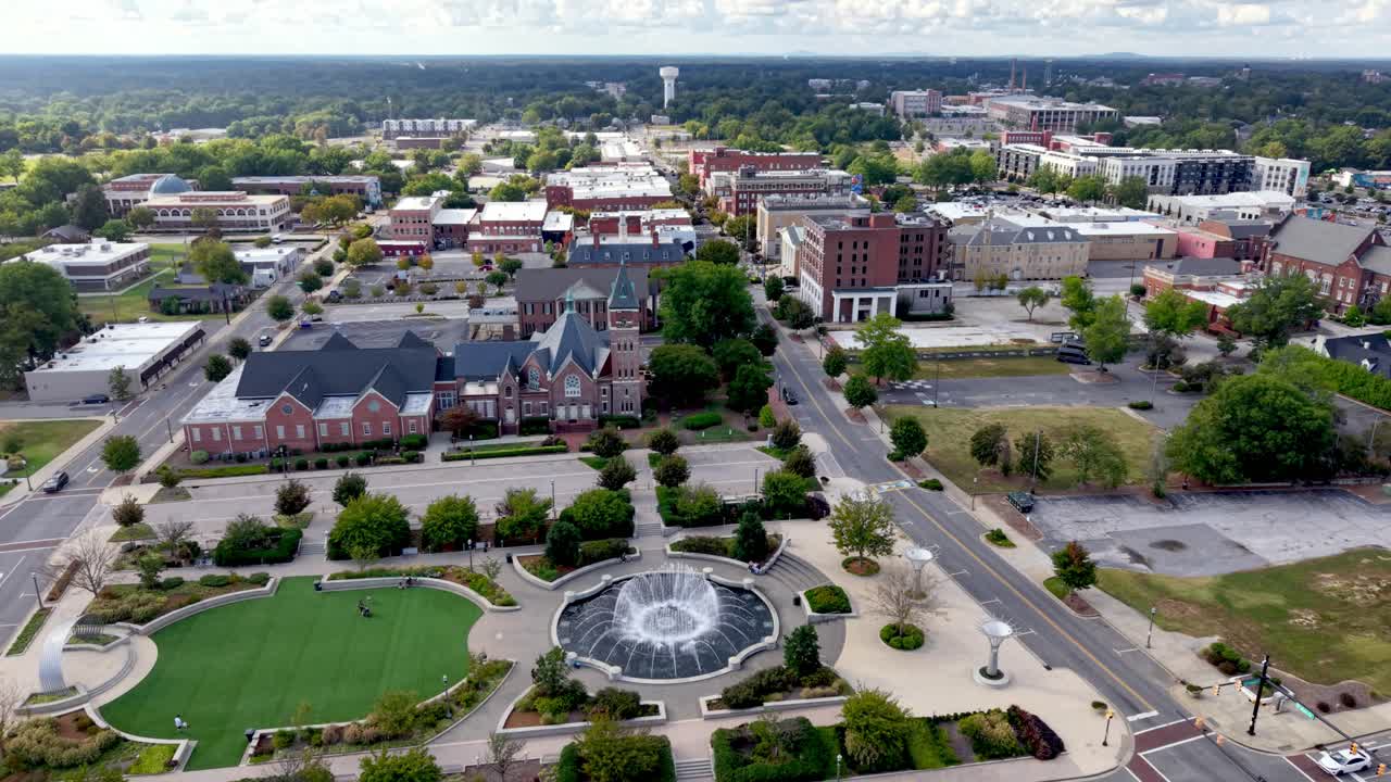 Aerial View of a Quaint Town Square with Fountain and Historic Buildings