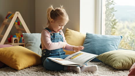 cute little girl reading a book at home