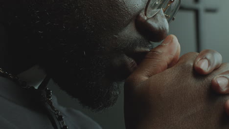 close-up view of faithful priest praying deeply in church