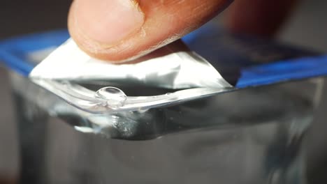 a single water drop in a clear plastic container