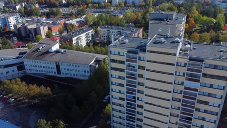 aerial climbs yellow apartment building in northern city in autumn