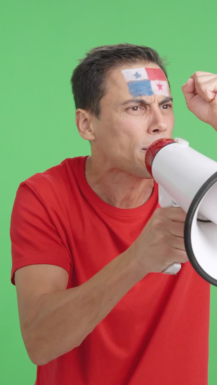 Excited man with panamanian flag on face using a megaphone