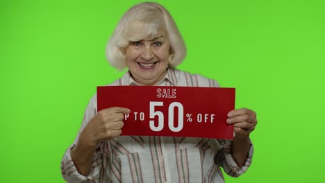 Senior-grandmother-showing-Up-To-50-percent-Off-inscription,-advertising-discounts,-looking-amazed