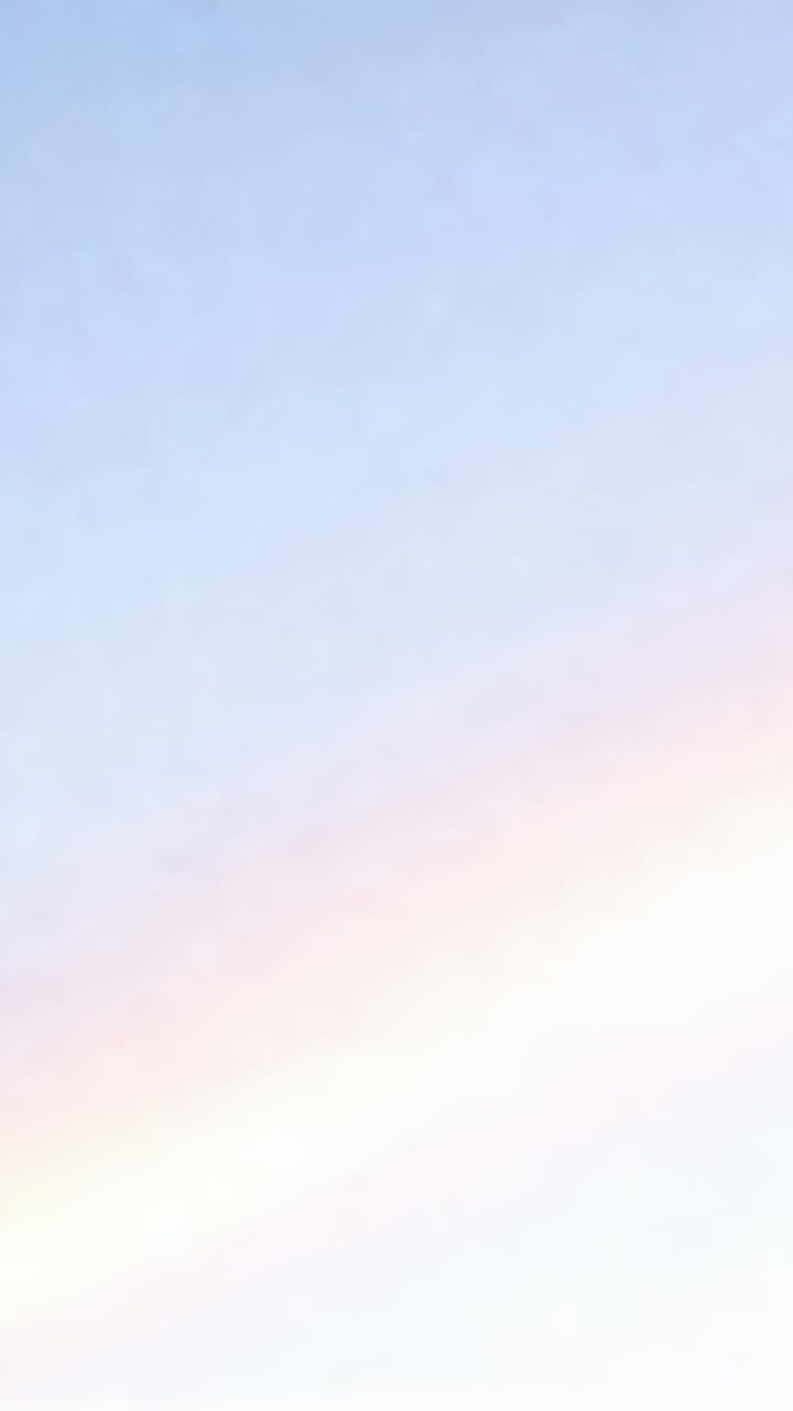 Vertical video: Displaying pale-pink cloud shifting tone during sunrise over open sky, haze band