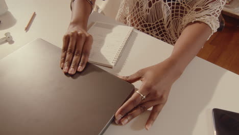 black girl opening laptop and working online at home