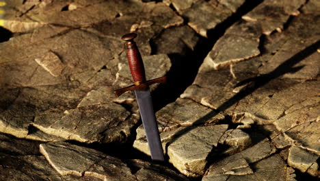 excalibur sword in rocky stone at sunset