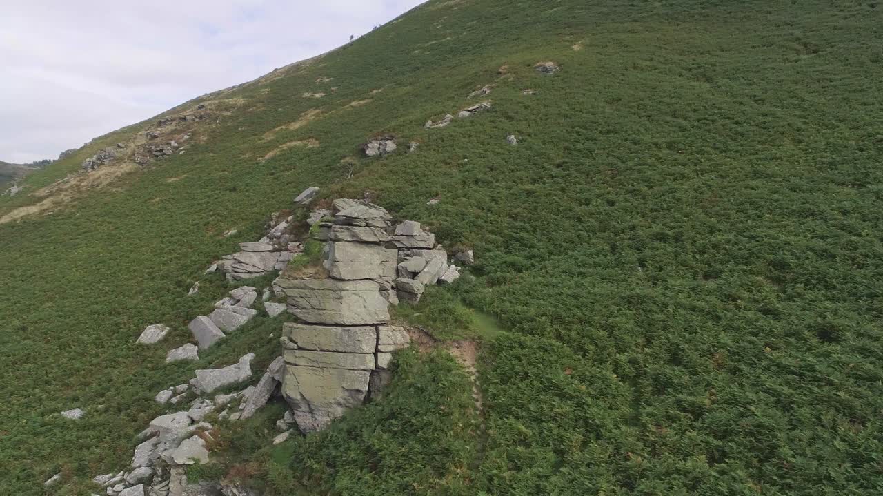 Mountain landscape with rock formations and green vegetation