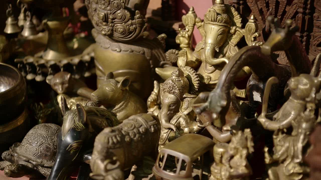 Souvenirs For Sale in a Nepal Market, Gold Metal Figures of Hindu Gods and deities in a Shop at a Hindu Temple at Bhaktapur Ancient City in Nepal