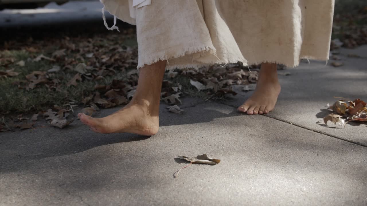 A dramatic slow motion closeup of man dressed as Jesus