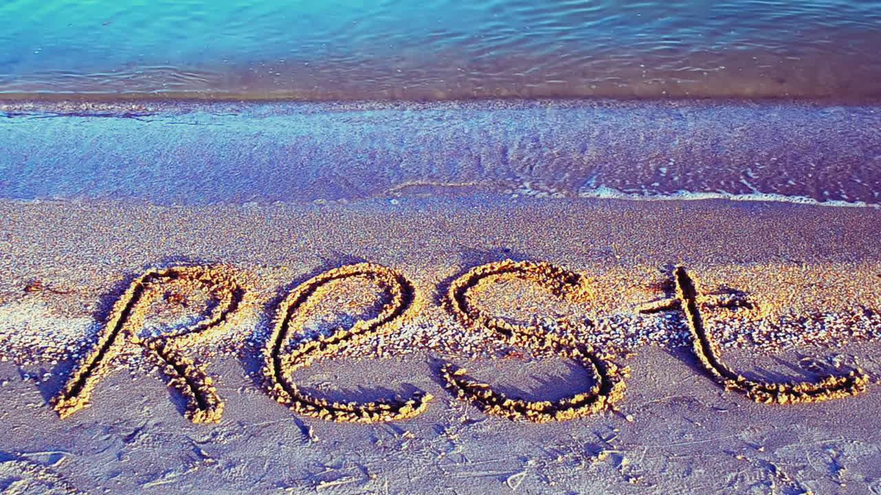 Inscription rest on sand, the beach. Inscription on sand, the beach