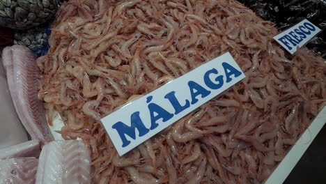 variety of seafood at the spanish fish market stall in the city of seville, spain