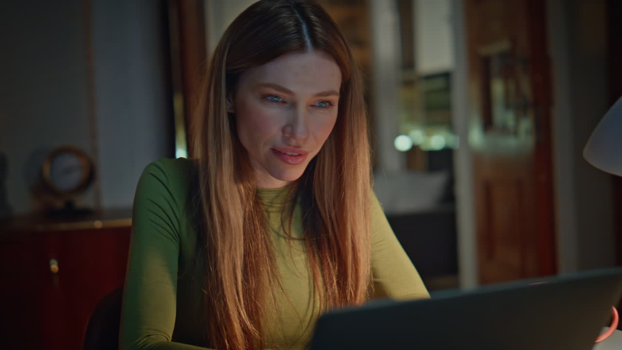 Businesswoman working computer evening apartment close up. Woman reading email