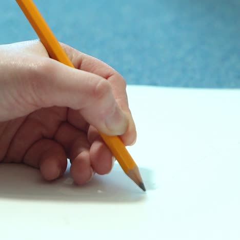 female hand drawing with a pencil in sketchbook. young woman learns to draw.