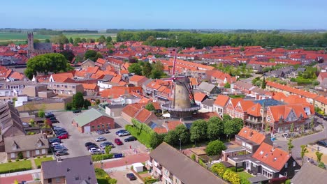 aerial over classic dutch holland town with prominent windmill sluis netherlands 1