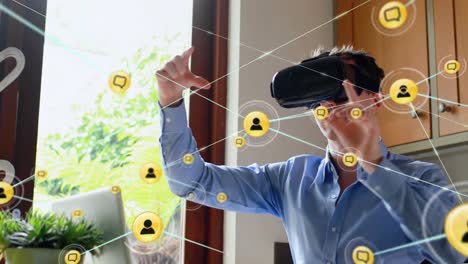 Animation-of-network-of-connections-with-icons-over-man-wearing-vr-headset