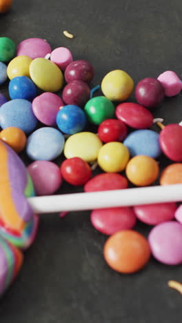 video of colourful lentils and lollipop on grey background