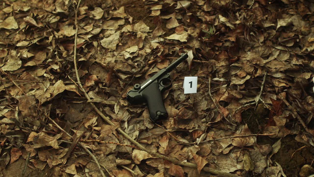 investigación de la escena del crimen, poniendo marcador con número cerca del arma, disparo de cierre