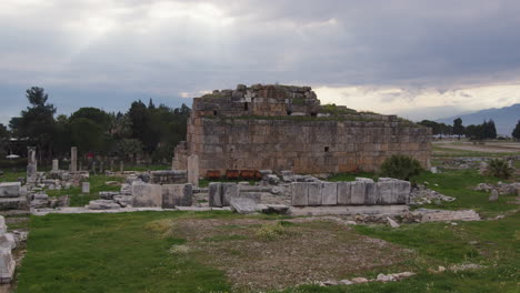 the ruins of a building with the sunset behind in hierapolis