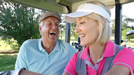 Two-golfers-driving-in-their-golf-buggy-