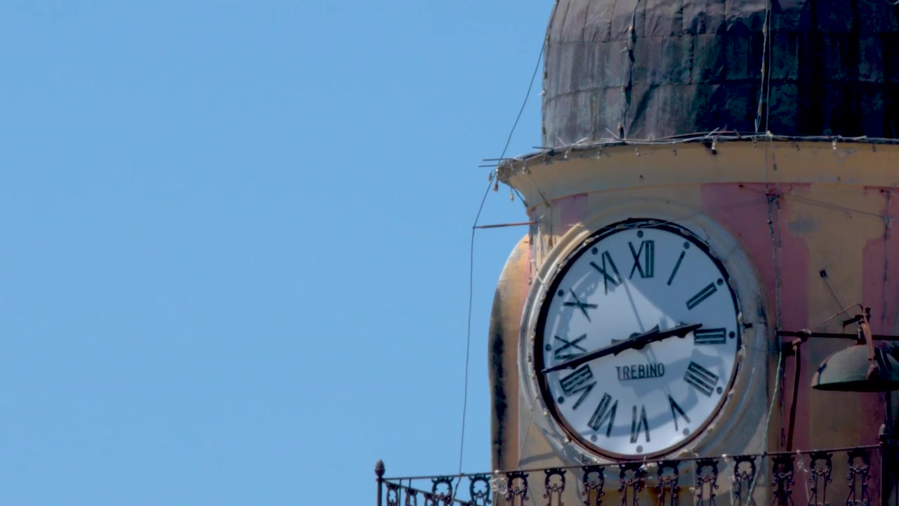 Close-up of an Old Clock Tower Against a Clear Blue Sky