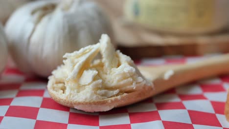 garlic butter on wooden spoon