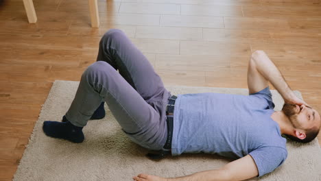 man with a headache laying on the floor