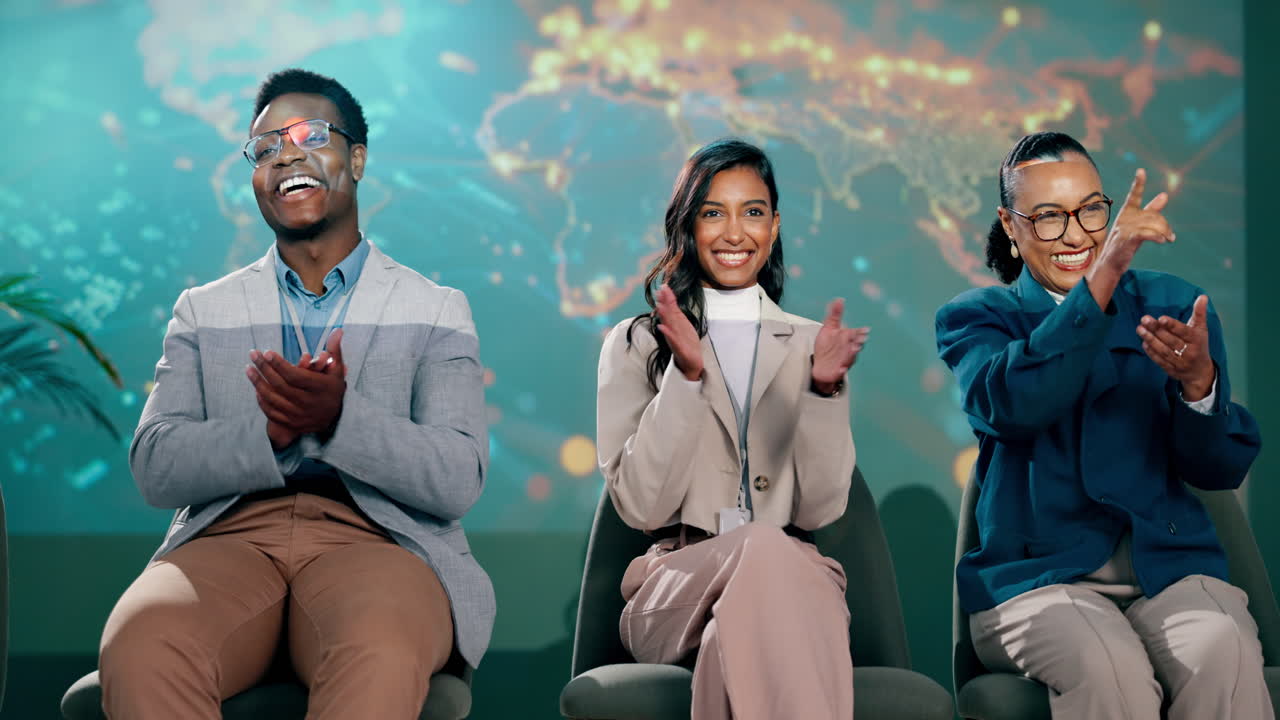 Three business people at a conference clapping