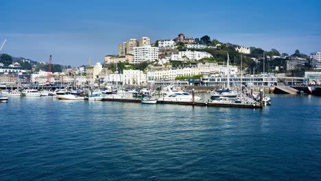 panning timelapse of torquay outer harbor and marina on a sunny day. torbay, devon, england, uk