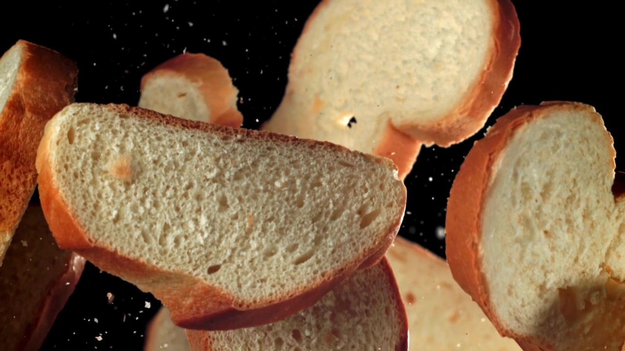 Sliced Bread and Crumbs Floating Upwards in Slow Motion