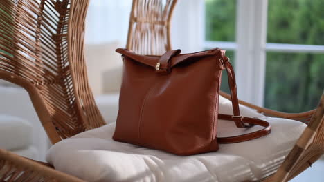 brown leather bag on a wicker chair