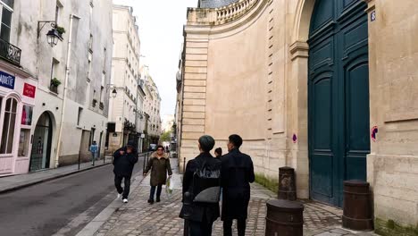 people walking along a charming paris street