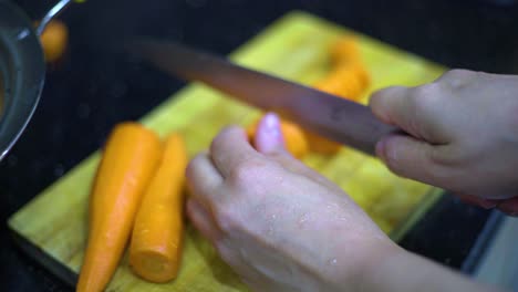 cutting the carrot on the worktop