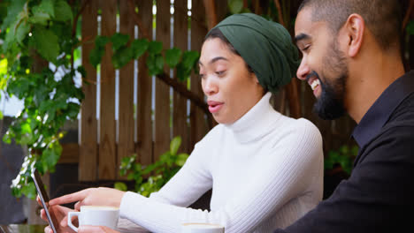 couple discussing over mobile phone in cafeteria 4k