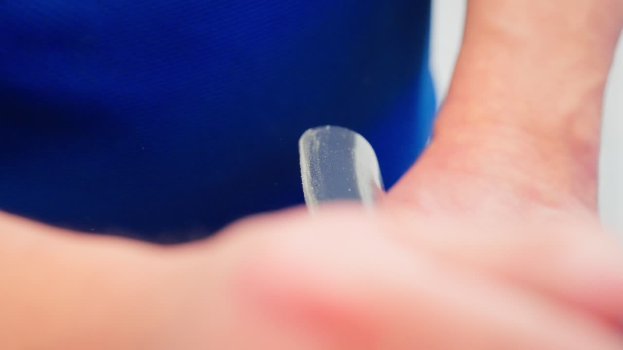 Close up slow motion captures man sanding dining chair back with sandpaper