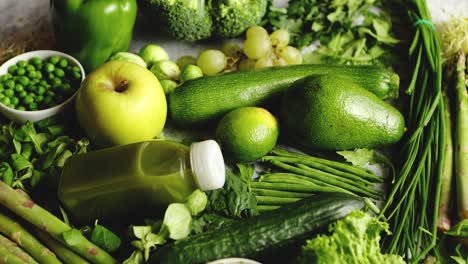 green antioxidant organic vegetables  fruits and herbs placed on gray stone