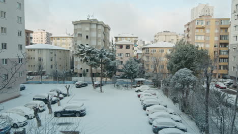 timelapse of snow falling scenery with buildings and apartments while sun rising on cityscape with cloudy sky