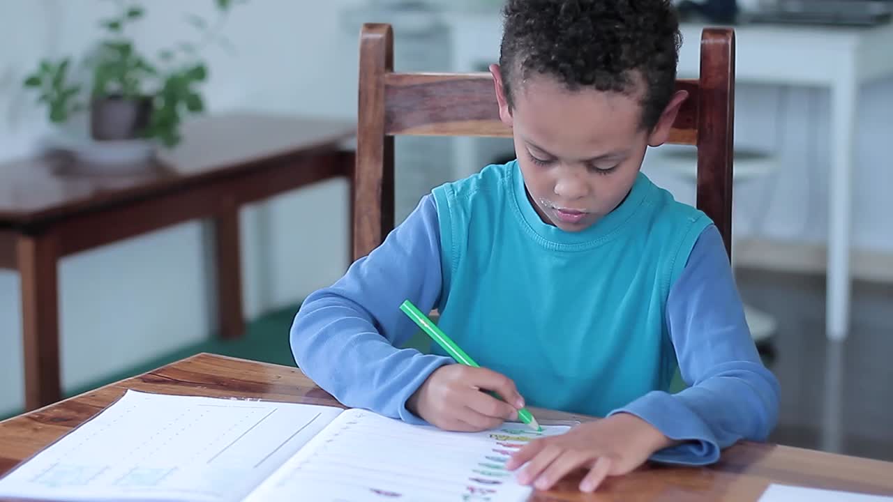 School boy learning at home educational teaching with mother stock footage