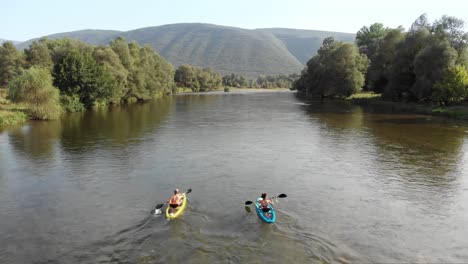 drone video flying upwards following two people kayak nestos river greece summer