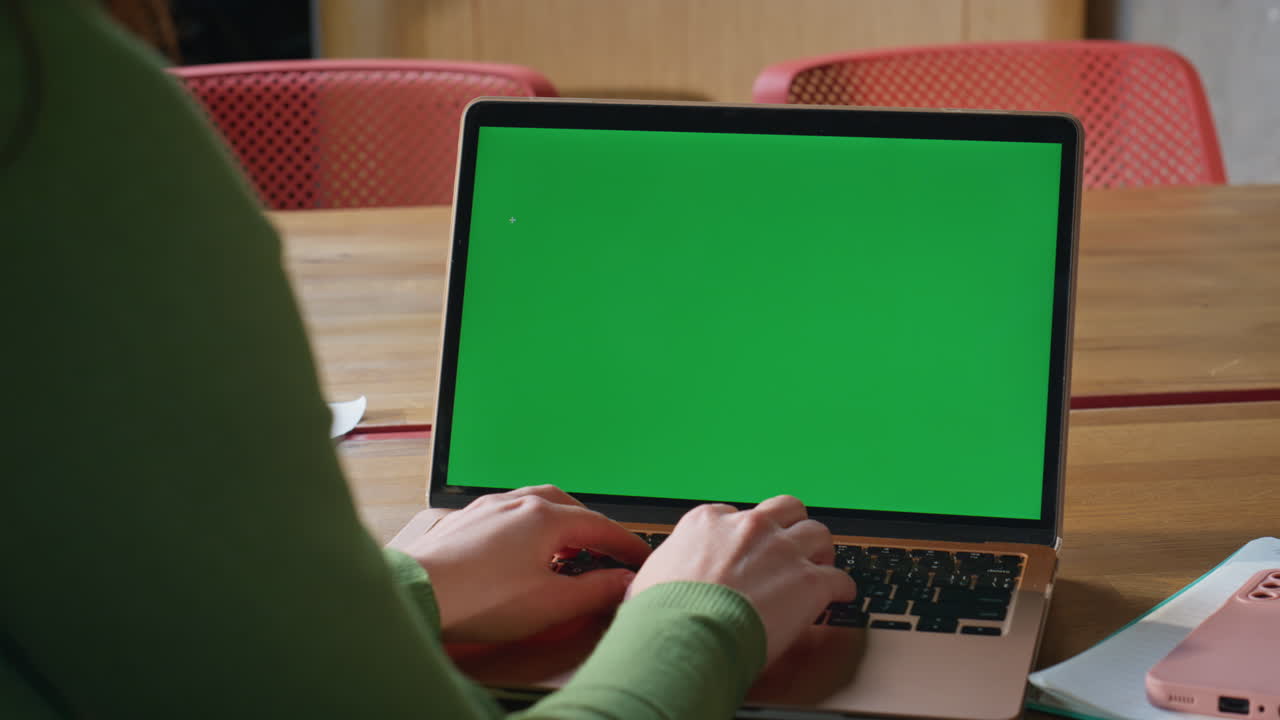 Hands typing mockup laptop keyboard browsing application at workplace closeup