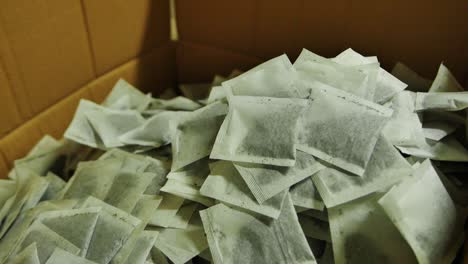 tea bags dropping into box in factory