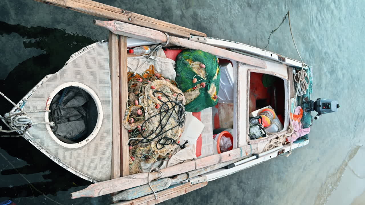 Moored boat with lots of fishing accessories in the sea port, Aegean sea in Ormos Panagias, Greece