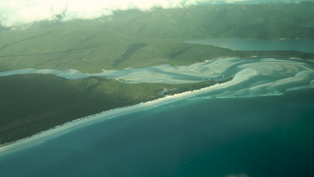 White silica sands of Whitehaven beach illuminated by golden hour sunlight
