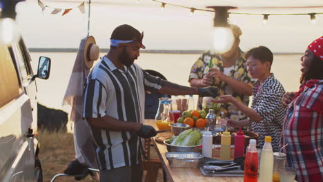 cheerful multiethnic people buying street food at summer festival