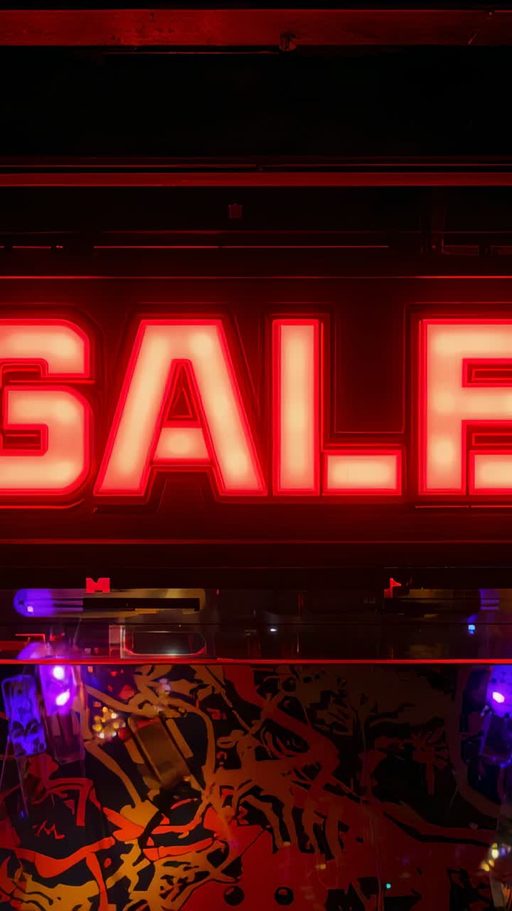 Vertical video: Starting red SALE neon promoting sale at shopfront, panel reflecting LEDs, left dot